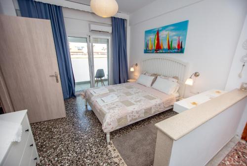 a bedroom with a large bed and a window at T H E BERLIN Studios and Suites in Nea Vrasna