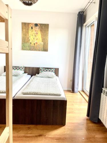 a bedroom with two beds and a painting on the wall at Sonja in Zator
