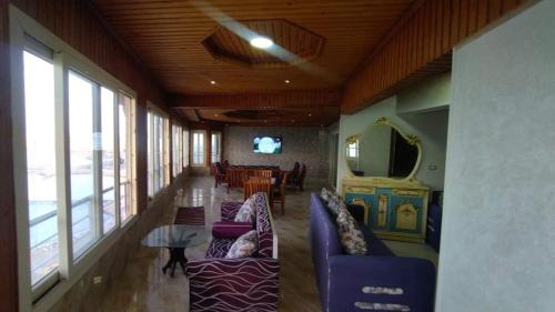 a living room with two purple couches and a table at Rest Inn in Kerak