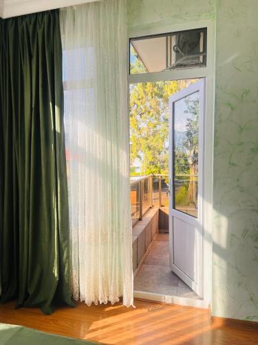 an open door in a room with a window at Apartments NITA in Batumi