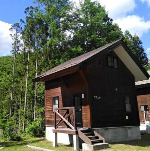 a small cabin with a wooden door in front of it at Miyori Hometown Experience Village Campsite (Nakam - Vacation STAY 34964v in Nikko