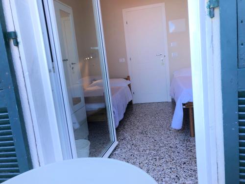 a mirror in a small room with two beds at Il Delfino in Tellaro