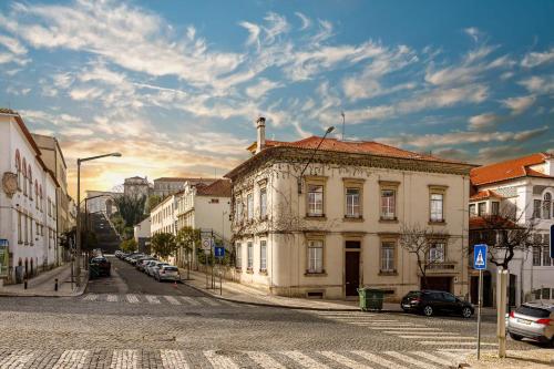 an old building on a street in a city at SKY Accommodations in Coimbra