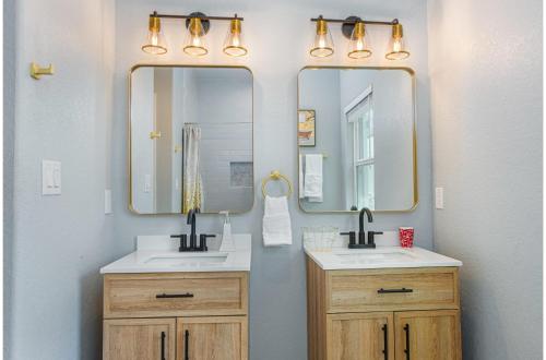 un baño con dos lavabos y dos espejos en Heaven-sent Convenient 4BR 3BA Near Downtown, en San Antonio