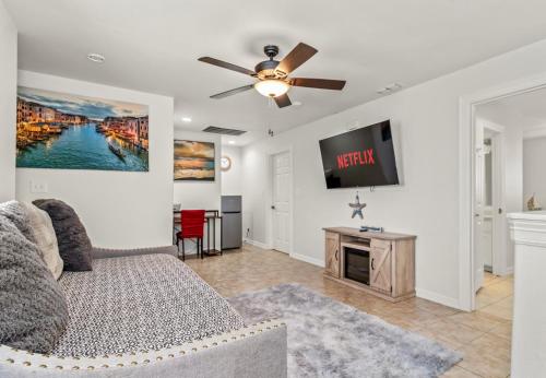 a living room with a couch and a flat screen tv at 8 Mins to SPI Beach Spacious 3BR with Backyard in Port Isabel
