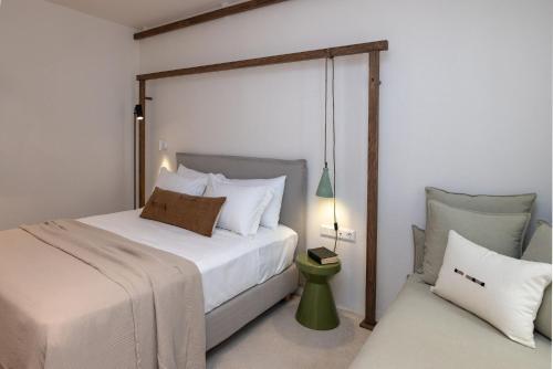a bedroom with a large bed and a night stand at casa eterna in Agios Romanos