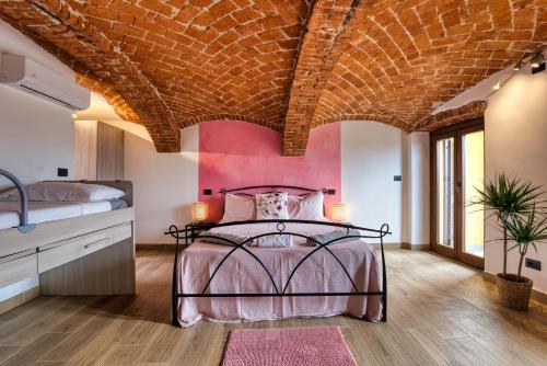 a bedroom with a bed and a brick ceiling at La Cantina Rent Rooms in Agliè