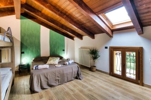 a bedroom with a bed in a room with wooden ceilings at La Cantina Rent Rooms in Agliè
