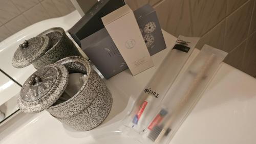 a white counter with a bottle of lipstick and a scarf at Top Central Stay - Cozy Bedroom & Kitchen in the Heart of the City and Hauptbahnhof in Wuppertal