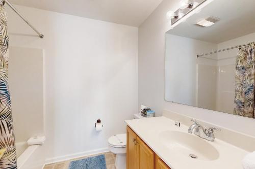 a bathroom with a sink and a toilet and a mirror at The Reserves of Nassau - 17295 Queen Anne Way in Lewes