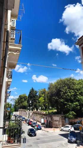 a city street with cars parked on the street at La Domvs del Borgo in Taranto