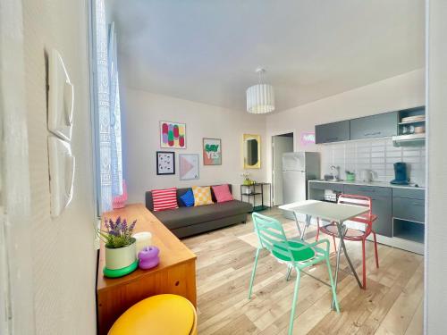 une cuisine et un salon avec une table et des chaises dans l'établissement Pétillant T2 rez-de-jardin, à Bonneville