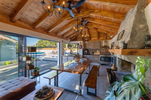a living room with a wooden ceiling and a table at Villa Idylee in Drniš