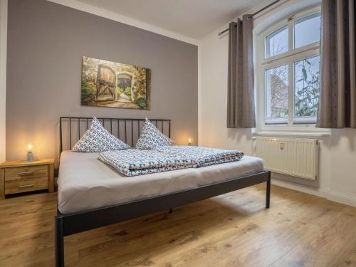 a bedroom with a bed with blue and white pillows at Ferienwohnung in der Mecklenburger Seenplatte in Buchholz