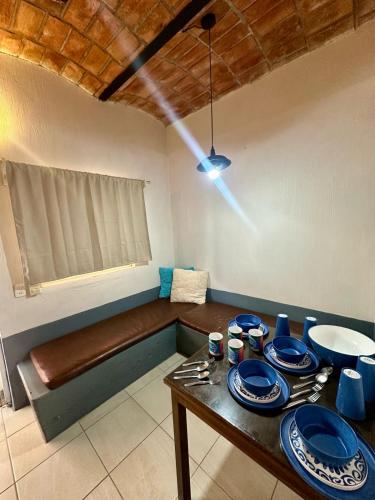 a room with a table with blue dishes on it at Bungalows Las Glorias in Rincon de Guayabitos
