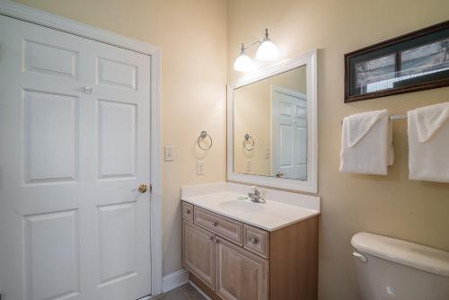 a bathroom with a sink and a mirror and a toilet at Litchfield Beach & Golf Resort in Pawleys Island
