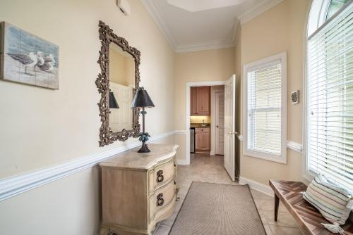 a room with a mirror on the wall and a dresser at Litchfield Beach & Golf Resort in Pawleys Island