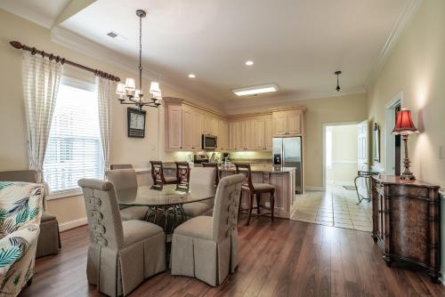 a kitchen and living room with a table and chairs at Litchfield Beach & Golf Resort in Pawleys Island