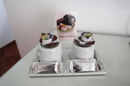 a white table with two bottles ofodorizers on it at Hotel Malaga Picasso in Málaga