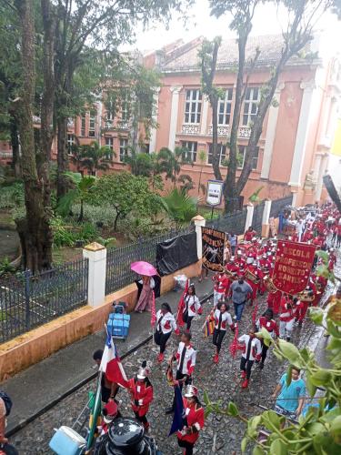 a group of children dressed in costumes walking down a street at Suites casa da lucia in Salvador