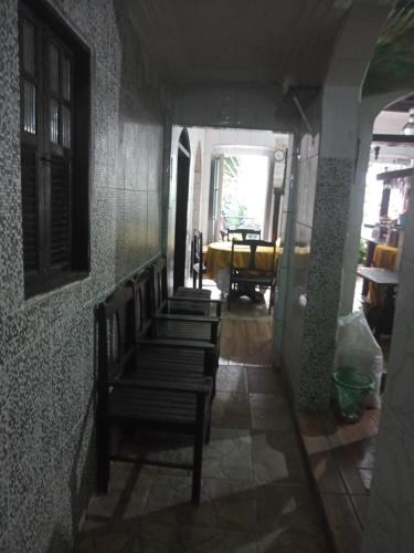 a group of chairs sitting in a hallway at Suites casa da lucia in Salvador