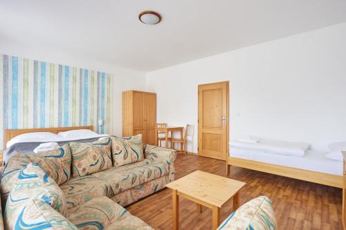 a living room with a couch and a bed at Resort Pasecna in Přední Výtoň