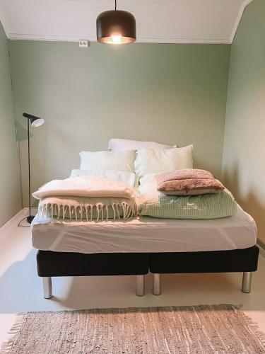 a bedroom with a bed with pillows on it at Modern house 5 bedrooms 2 baths sentral in Bodø
