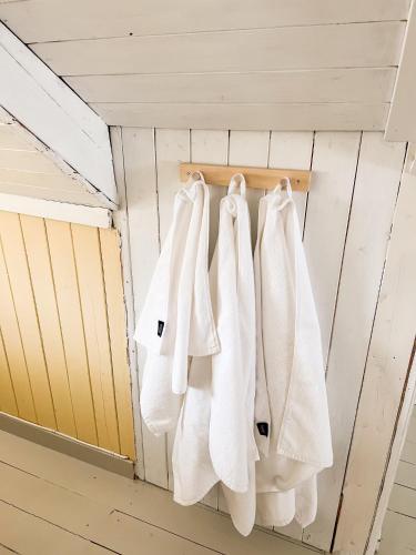 a group of white towels hanging on a wall at Modern house 5 bedrooms 2 baths sentral in Bodø