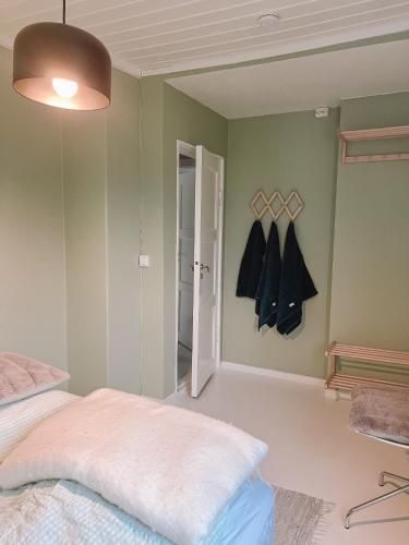 a bedroom with a bed and a closet with hangers at Modern house 5 bedrooms 2 baths sentral in Bodø