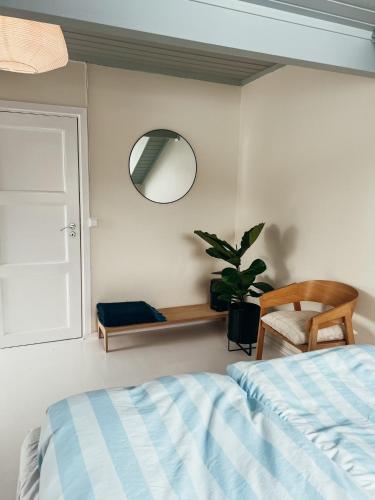 a bedroom with a bed and a mirror and a plant at Modern house 5 bedrooms 2 baths sentral in Bodø