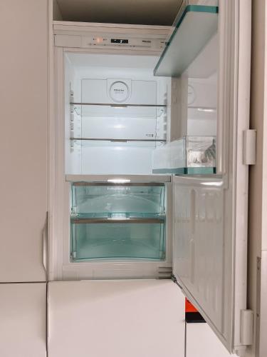 an empty refrigerator door is open in a kitchen at Modern house 5 bedrooms 2 baths sentral in Bodø