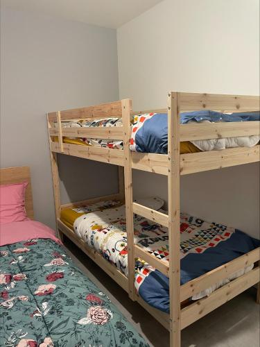 two bunk beds in a room with a bed at Gîtes de Chaum in Chaum
