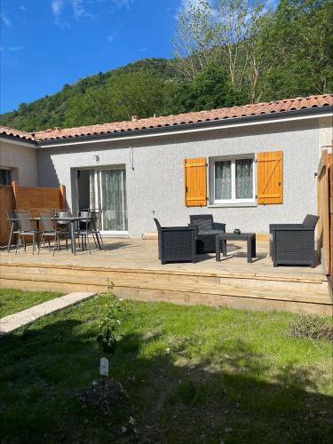 a wooden deck with furniture and a table and chairs at Gîtes de Chaum in Chaum