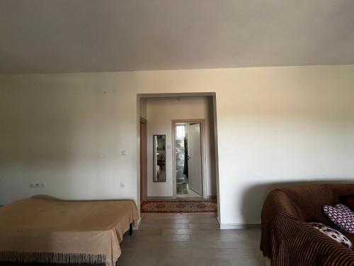a room with two beds and a mirror at Maria's house with garden in Sozopoli