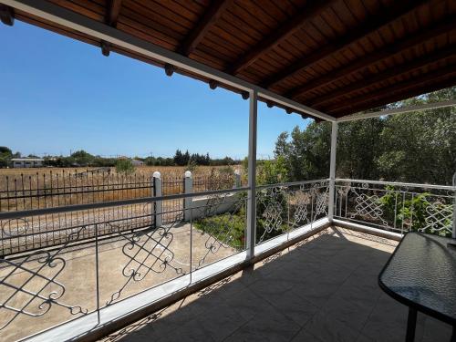 a screened porch with a view of a field at Maria's house with garden in Sozopoli