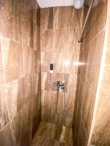 a bathroom with a shower with a stone wall at BOUTIQUE VILLA 84 in Sarajevo