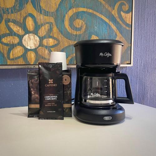a coffeemaker sitting on top of a counter with a coffee maker at Hotel Hacienda Tetakawi in San Carlos