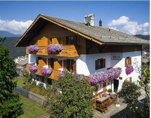 a house with flowers on the front of it at B&B Garni Lantschner in Kastelruth
