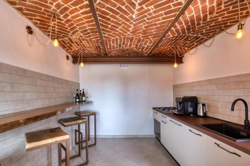 a kitchen with a sink and a counter top at La Cantina Rent Rooms in Agliè