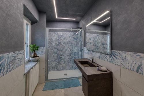 a bathroom with a shower and a sink at La Cantina Rent Rooms in Agliè