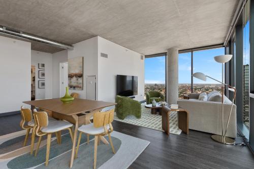 a living room with a table and chairs and a couch at Fulbrix Bright Designer Apartments with West Loop Views in Chicago