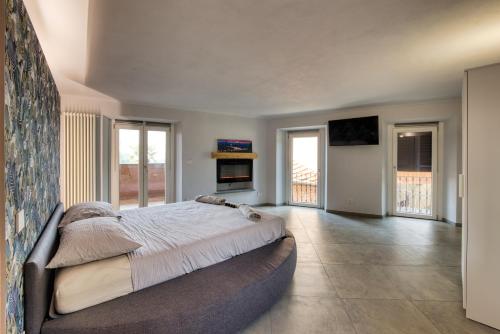 a bedroom with a large bed in a room with windows at La Cantina Rent Rooms in Agliè