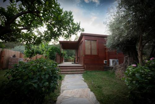 a small wooden house with stairs leading to it at El jardín del Edén in Órgiva