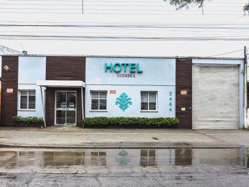 a hotel sign on the side of a building at Coimbra Hotel Pousada in Pelotas