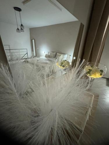 a bedroom with a bed with white feathers on it at La farfalla del vicolo in Larino