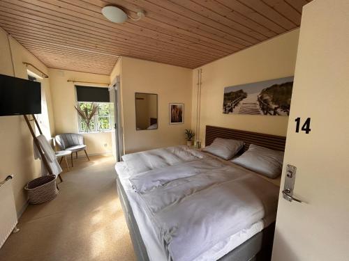 a bedroom with a large white bed in a room at Strandidyl Bed and Breakfast in Haderslev