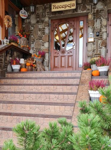 a front door of a store with pumpkins in front at Willa Roztoka & SPA - idealne miejsce dla Twojej rodziny in Bukowina Tatrzańska