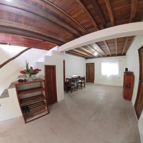 a large room with a wooden ceiling and a table at Candurumy Lodge in Tena