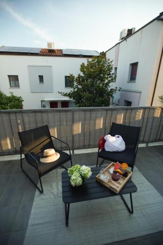 a patio with two chairs and a table on a balcony at Elly in Ankaran