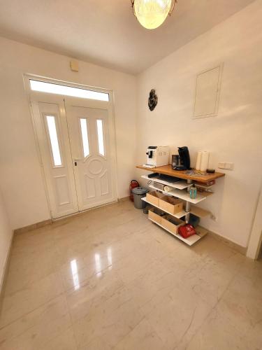 a room with a white door and a counter with a microwave at Apartments Pitve in Jelsa